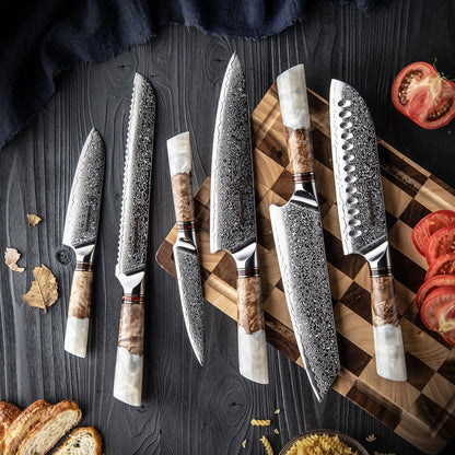 Damastmesser-Set mit weißem Harzgriff auf Holzbrett, Tomaten und Brot, edle Küchenutensilien